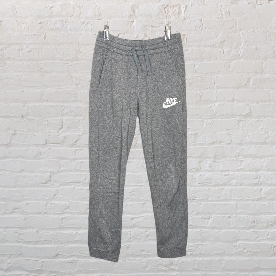 Grey Nike jogger sweatpants with white logo, featuring an adjustable drawstring waistband.