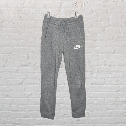 Grey Nike jogger sweatpants with white logo, featuring an adjustable drawstring waistband.