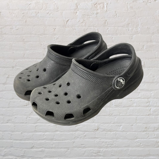 Pair of gray classic clog shoes with ventilation holes and adjustable heel strap.