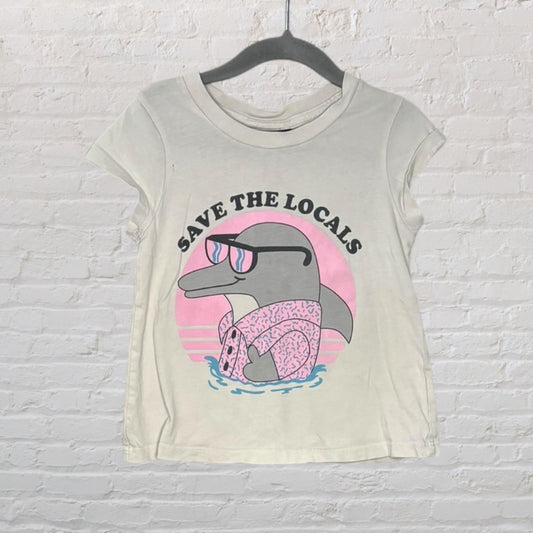 Cream T-shirt with a cartoon dolphin wearing sunglasses and a flotation device, with the text 'Save the Locals' on the chest.