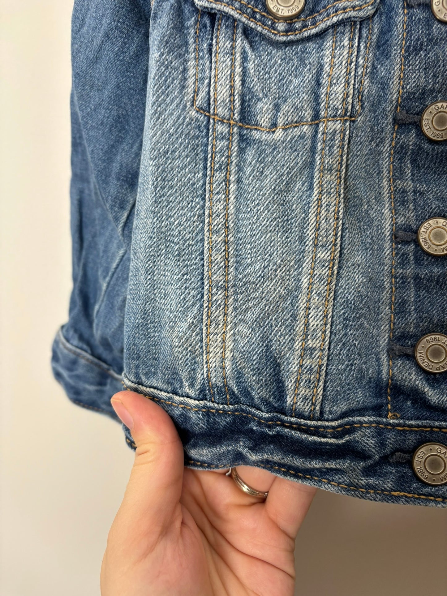 Blue denim jacket with 'Belle' embroidered on the back with a silhouette and rose design.