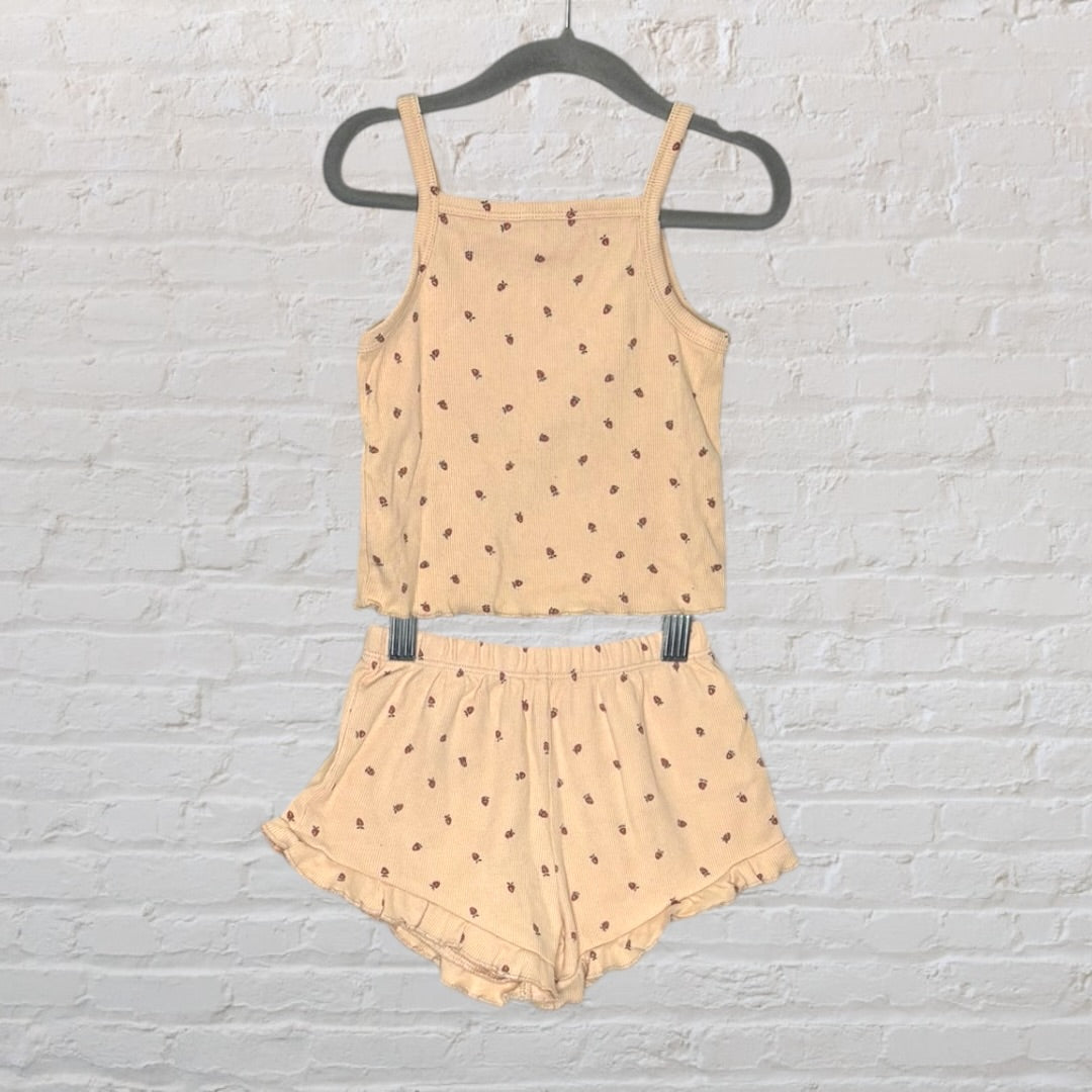 Beige sleepwear set featuring a tank top and shorts with a delicate floral print, displayed on a hanger.