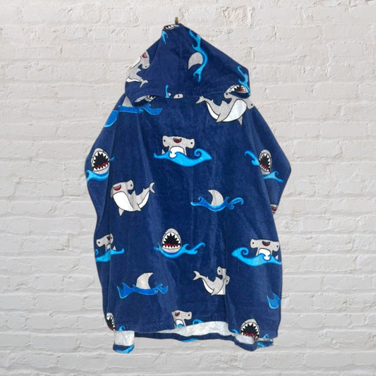 Navy blue hooded poncho with cartoon shark print, ideal for children, with a playful aquatic theme.
