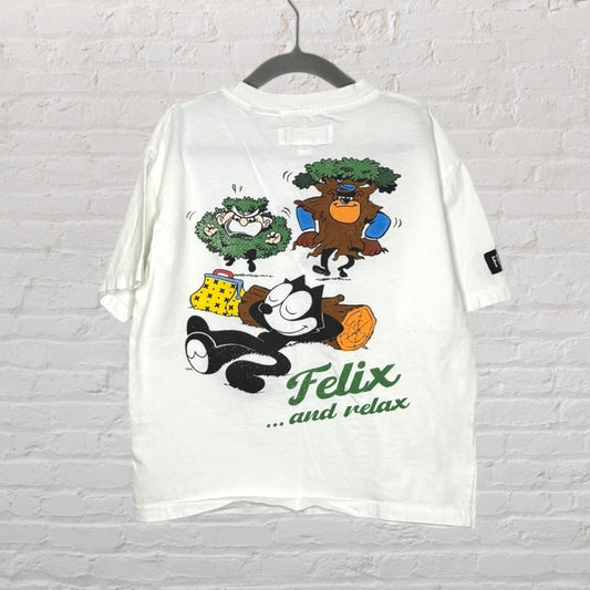 White T-shirt featuring a colorful graphic of Felix the Cat relaxing with trees and 'Felix... and relax' text.