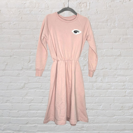 Blush pink midi dress with a single eye graphic on the chest, long sleeves, and cinched waist.
