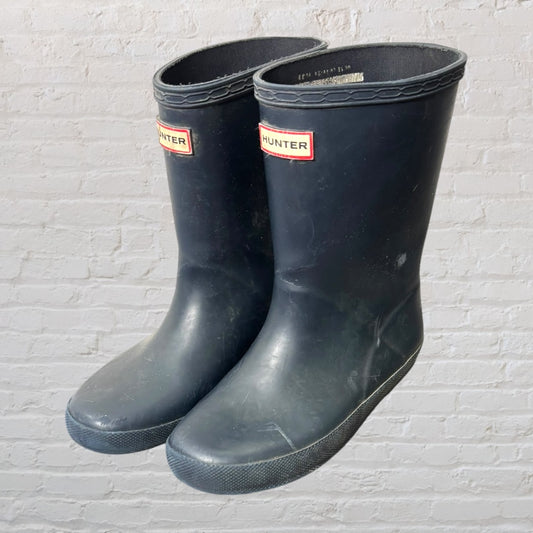 Pair of black Hunter rain boots with logo, showing minor scuffs.
