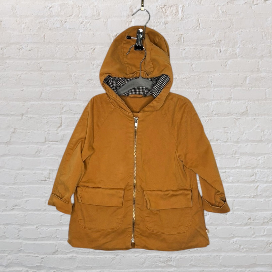 Mustard hooded parka with a checkered lining, featuring a front zipper and large front pockets.