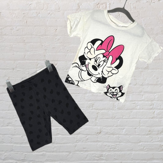 White Minnie Mouse graphic T-shirt with pink accents paired with black leggings featuring heart patterns.