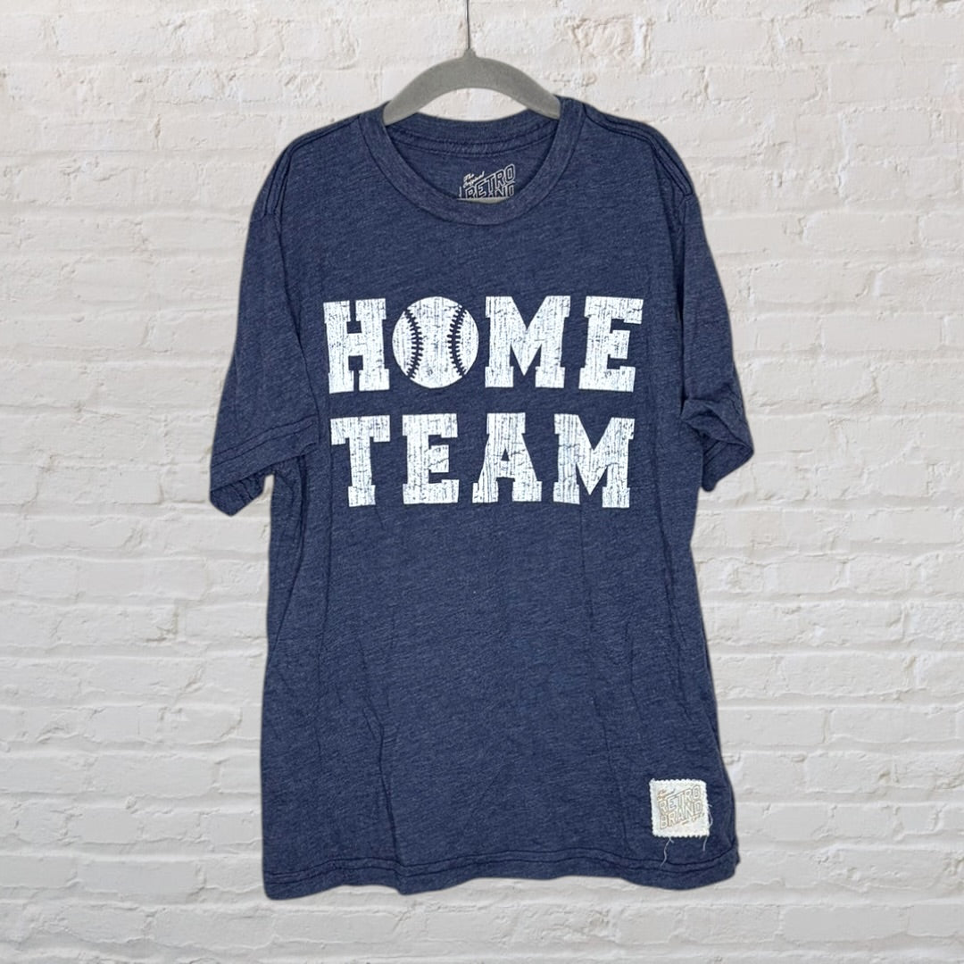 Navy blue t-shirt with 'Home Team' text and a baseball graphic by Retro Brand, hanging on a hanger.