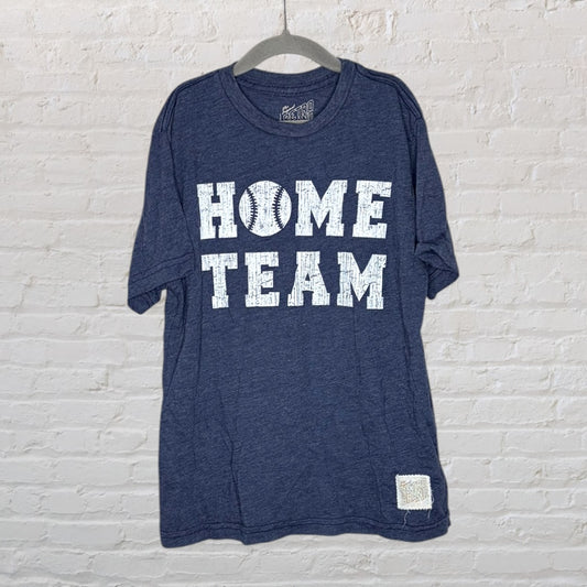 Navy blue t-shirt with 'Home Team' text and a baseball graphic by Retro Brand, hanging on a hanger.
