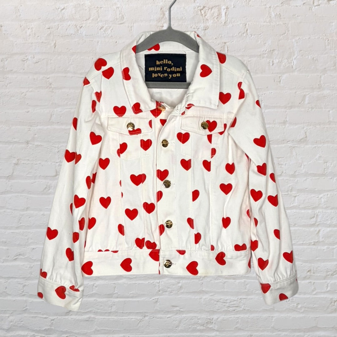 Mini Rodini white denim jacket with red heart prints and gold buttons.