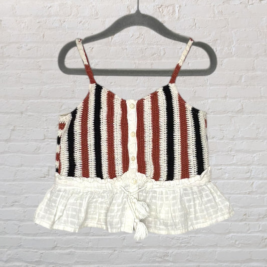 Striped knit camisole with brown, black, and white colors, featuring a button-down front and peplum hem with tassel tie.