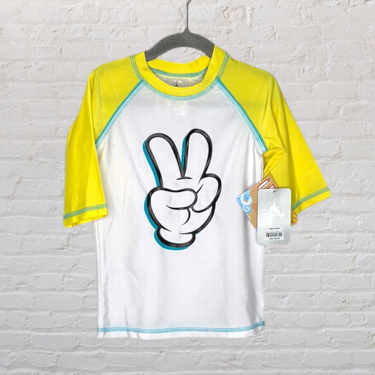 White and yellow Disney rash guard with peace sign graphic, made for swimwear, shown with tags attached.