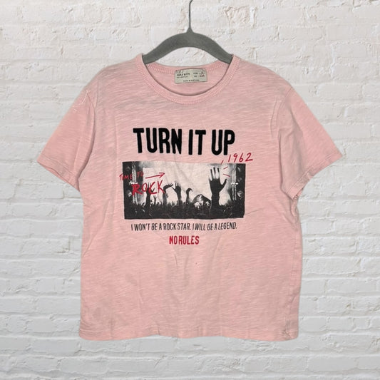 Light pink Zara Boys T-shirt with 'Turn It Up' and rock concert graphic, styled in a casual vibe.