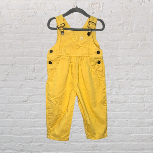 Yellow children's overalls with adjustable straps and side buttons, featuring pockets.