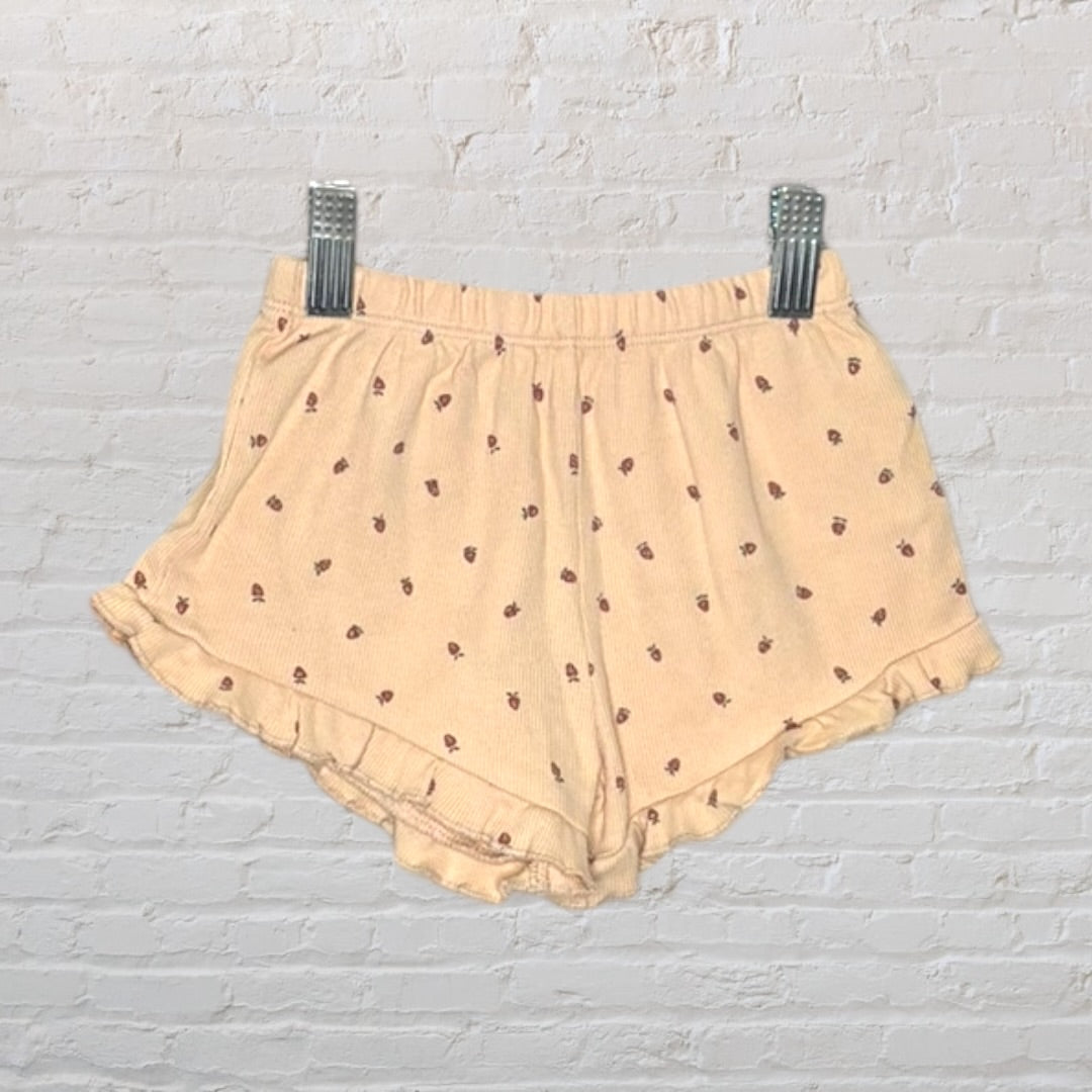 Beige sleepwear set featuring a tank top and shorts with a delicate floral print, displayed on a hanger.