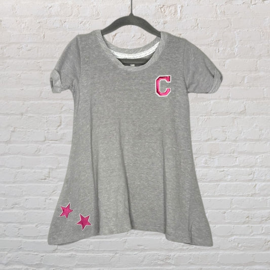 A gray T-shirt dress with rolled sleeves, featuring a pink 'C' patch on the chest and two pink star patches near the hem.