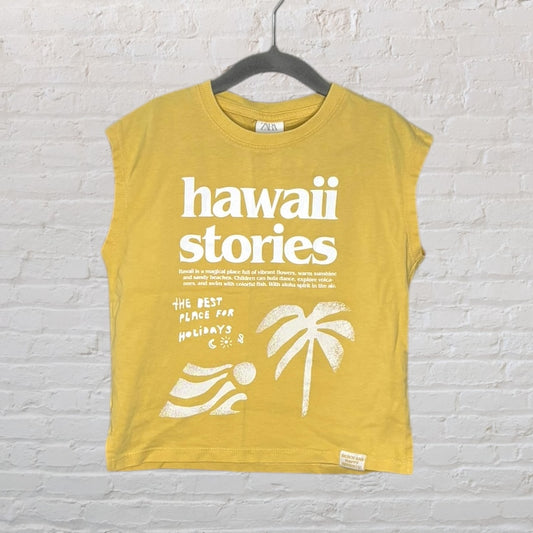 Mustard yellow sleeveless tee with white 'Hawaii Stories' print and tropical graphics, by Zara.