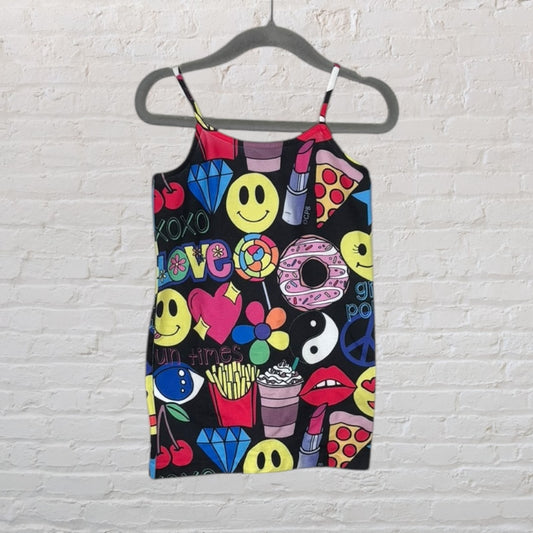 Black camisole dress with colorful graphic prints including smiley faces, peace signs, and other fun motifs.