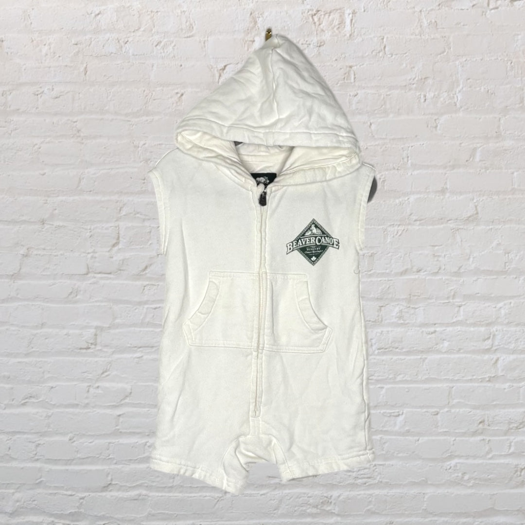 White sleeveless hooded romper with Beaver Canoe logo and front pockets.