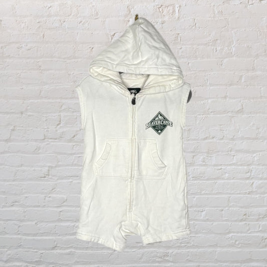 White sleeveless hooded romper with Beaver Canoe logo and front pockets.