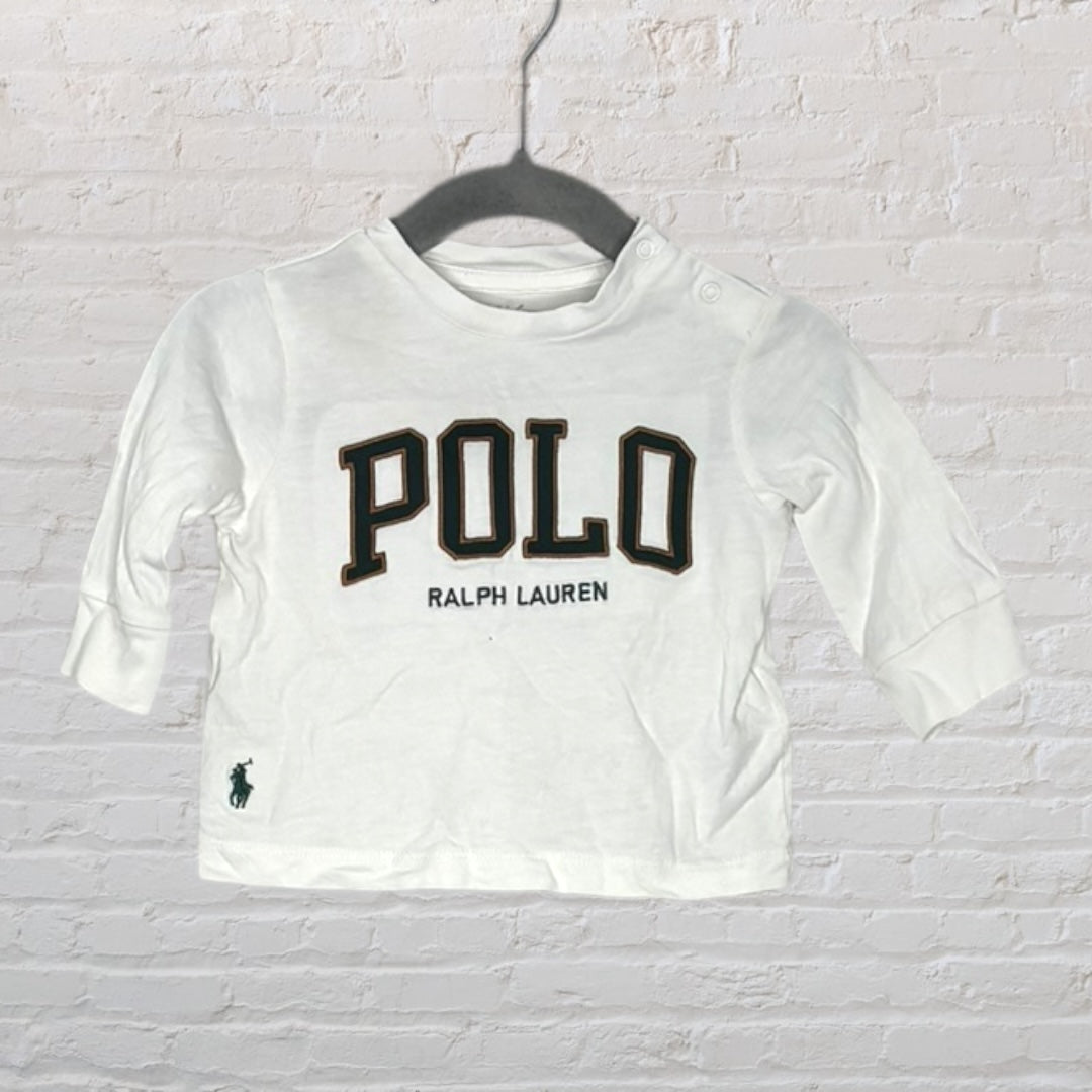White baby long sleeve top with 'POLO RALPH LAUREN' printed on the front, featuring a side polo player logo.