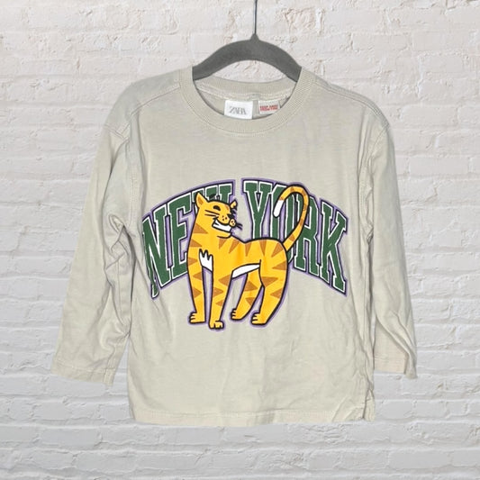 Beige Zara long sleeve t-shirt with a bold 'New York' and tiger graphic in green and orange.