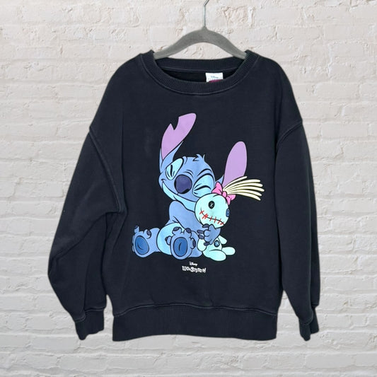 Black Disney sweatshirt featuring a graphic of Stitch holding a doll, with pastel colors on the front.