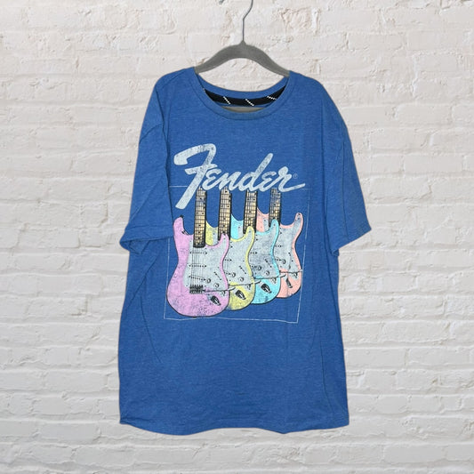 Blue Fender T-shirt with pastel-colored guitars graphic on a hanger.