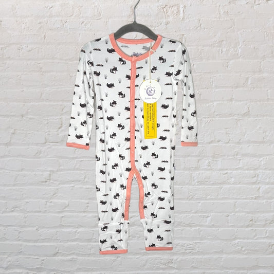 White baby one-piece with black animal prints and pink trim, hanging on a black hanger with tags attached.