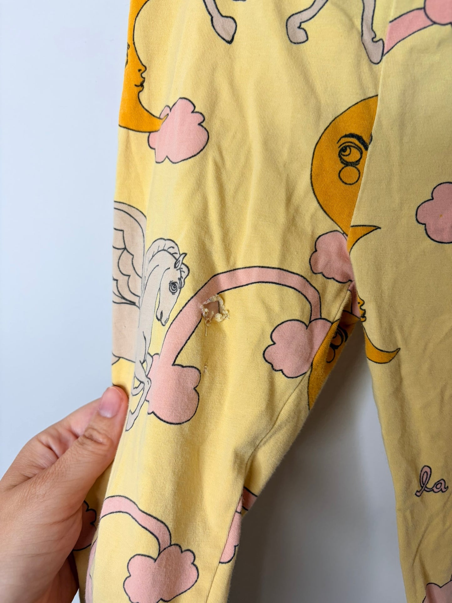 Multicoloured kids sleepwear set with various graphic designs including mermaids, cacti, and whimsical creatures.
