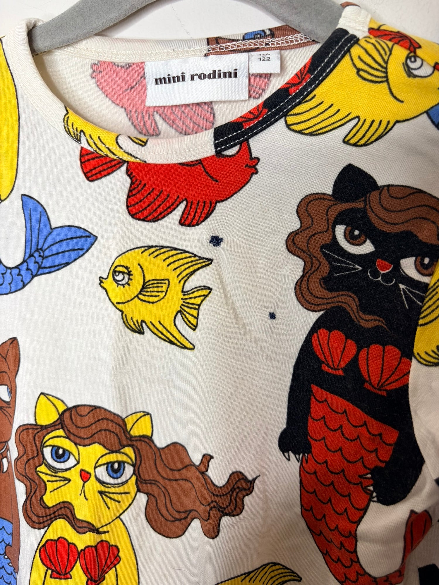 Multicoloured kids sleepwear set with various graphic designs including mermaids, cacti, and whimsical creatures.