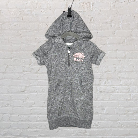 Grey hooded sweatshirt dress with short sleeves and a kangaroo pocket, featuring a pink Roots logo.