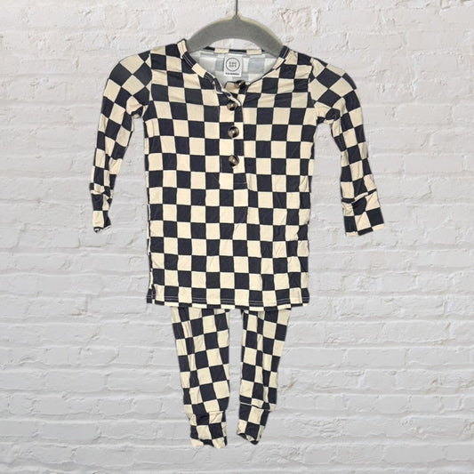 Black and cream checkered long sleeve pajama set with a henley neckline, hanging on a hanger.