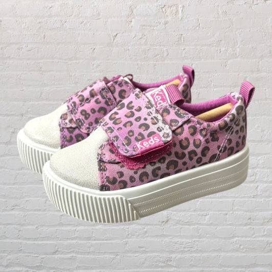 Pink and brown leopard print sneakers with Velcro closures from Keds, featuring white soles.