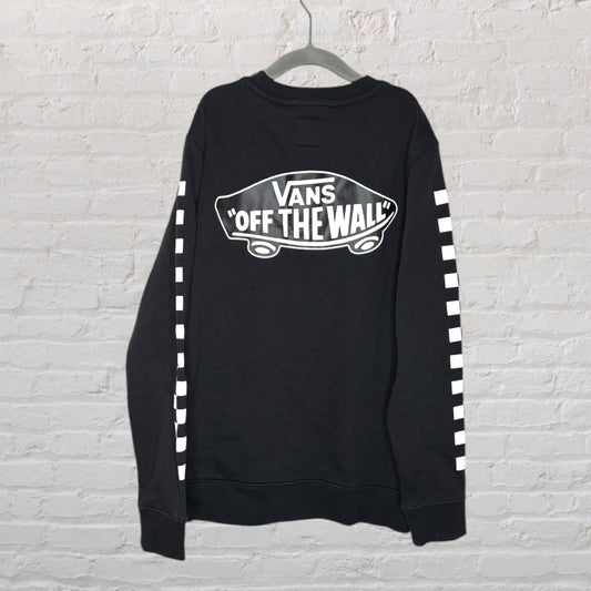 Black Vans sweatshirt with 'Off the Wall' logo and white checkerboard design on sleeves, hanging on a hanger.