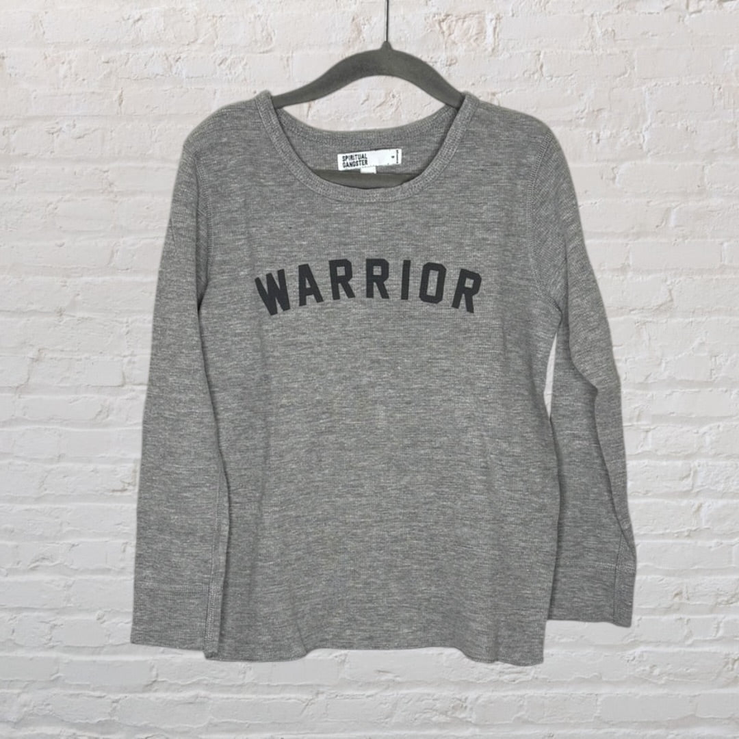 Grey long sleeve shirt with 'WARRIOR' text across the front, hanging on a hanger.