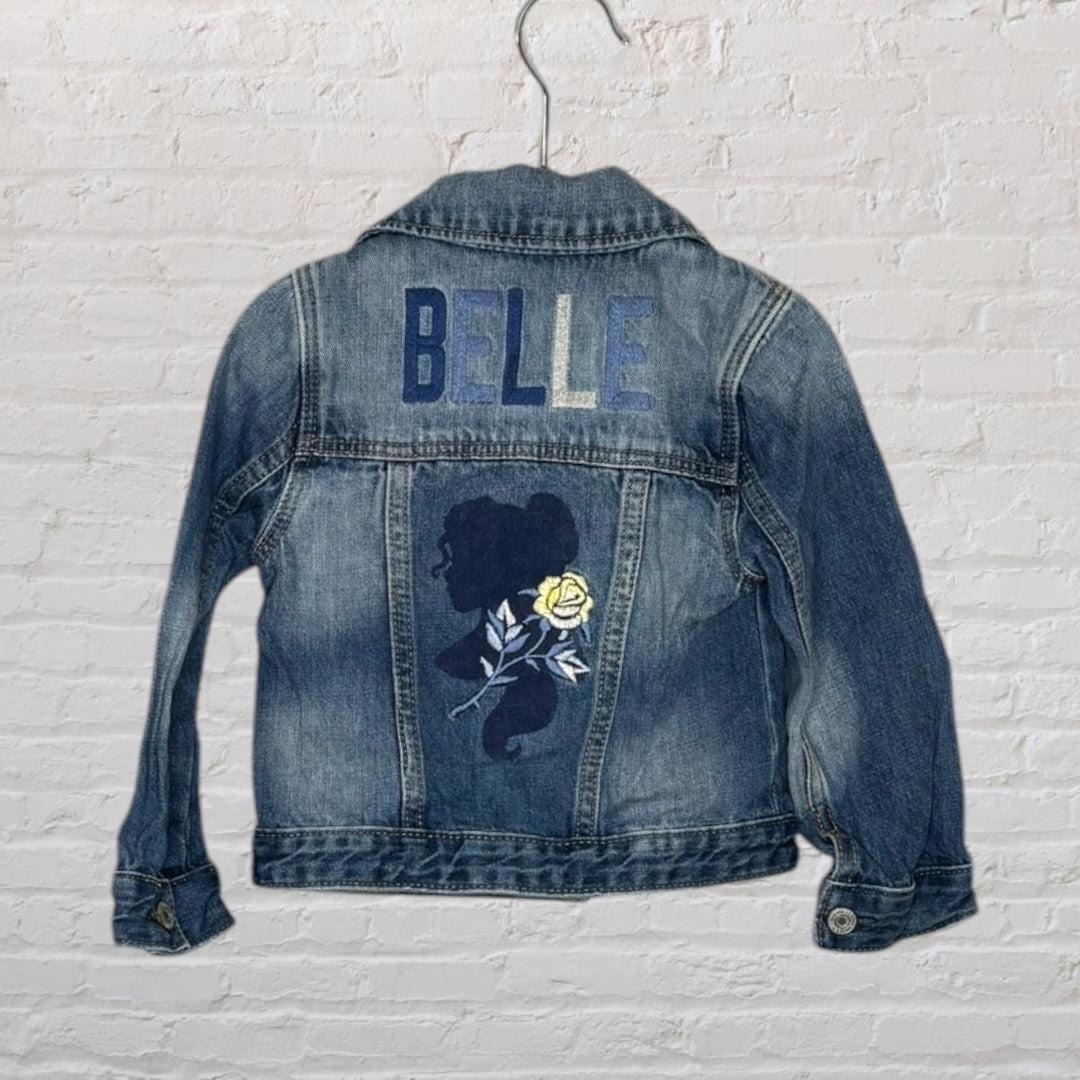 Blue denim jacket with 'Belle' embroidered on the back with a silhouette and rose design.