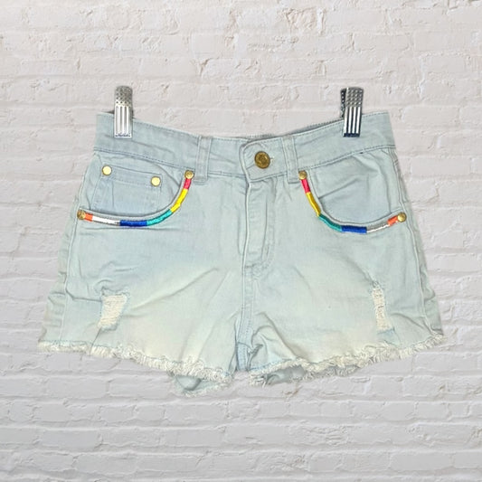 Light blue denim shorts with colorful embroidery on the pockets and frayed hem, displayed against a white background.