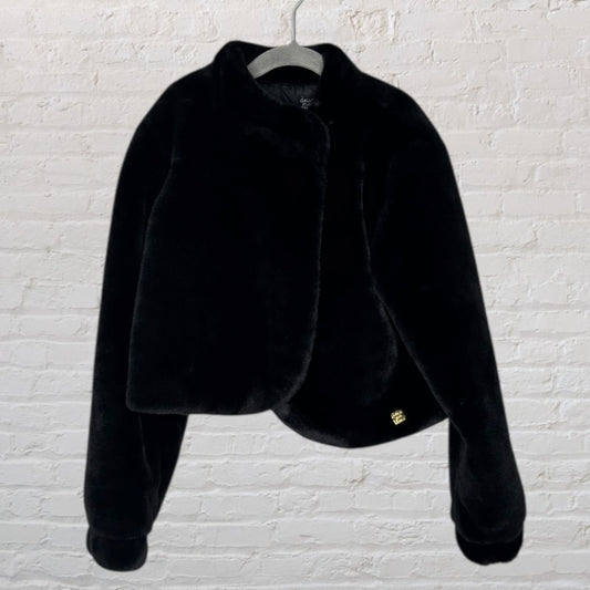 Chic black faux fur jacket with a luxurious texture and elegant design, displayed on a hanger.