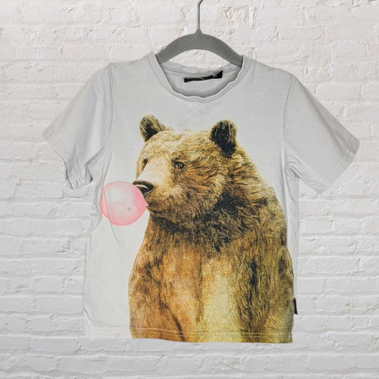 Off-white T-shirt featuring a graphic of a bear blowing pink bubblegum, hung on a hanger.