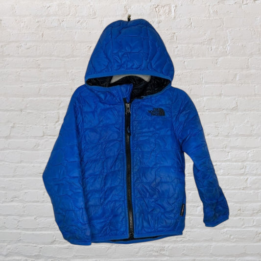 Blue quilted hooded jacket by The North Face, featuring a front zipper and brand logo.