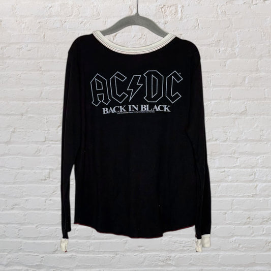 Black long sleeve AC/DC 'Back in Black' band t-shirt with white neckline hanging on a hanger.