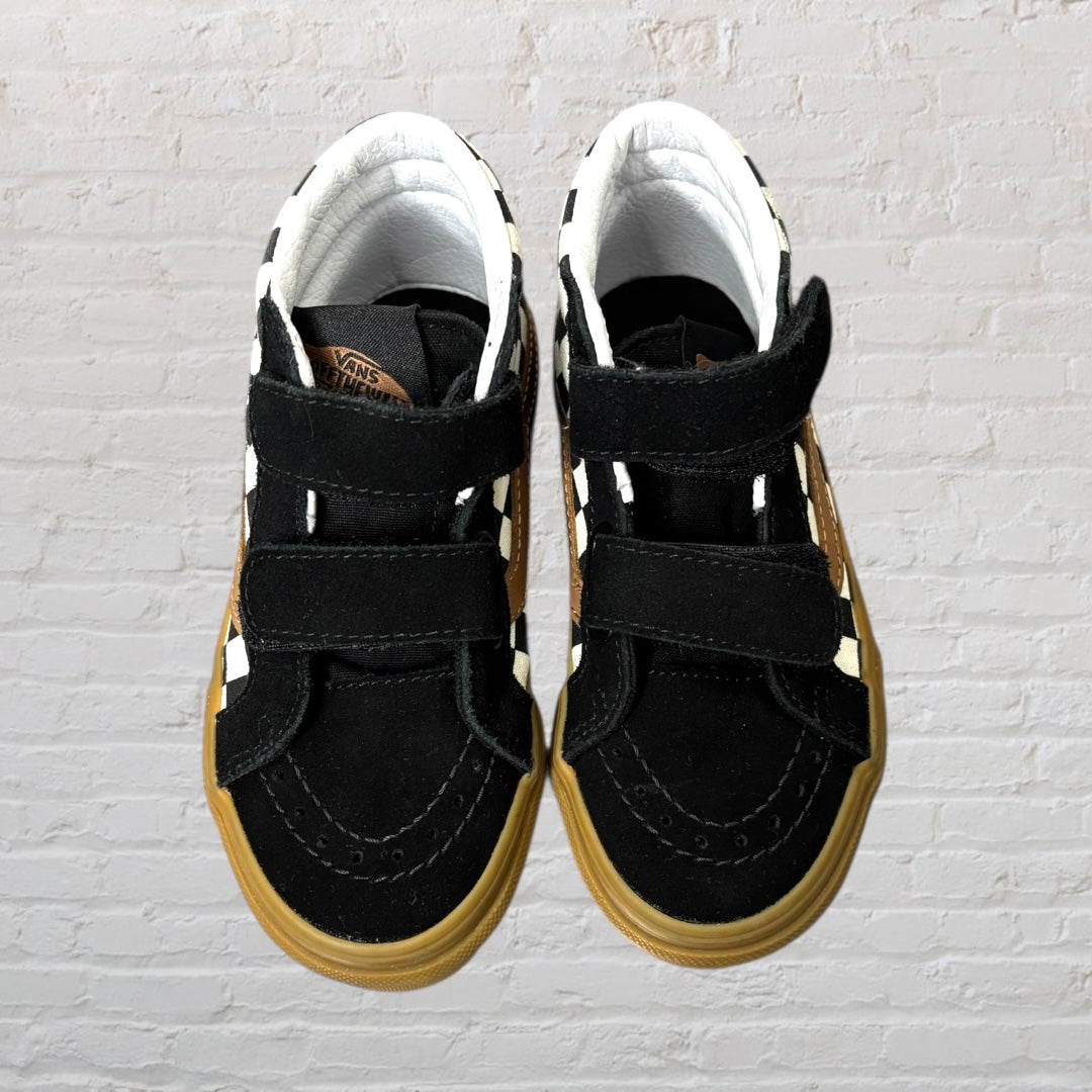 Pair of high-top sneakers with a black and white checkered pattern, brown detailing, and velcro straps.