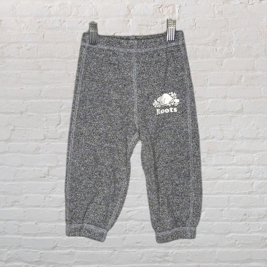 Grey Roots kids sweatpants with elastic waistband and cuffs, featuring a logo on the side.