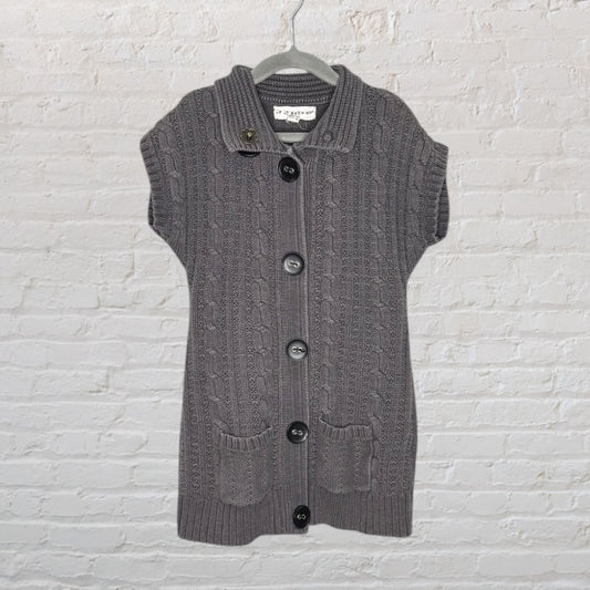 Gray cable knit vest with large buttons, cap sleeves, and front pockets on a hanger.