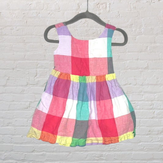 Colorful checkered sleeveless dress with a gathered waist, hanging on a black hanger.