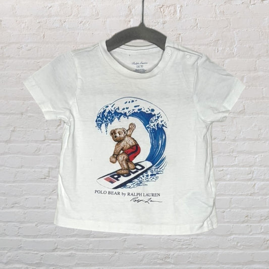 White Ralph Lauren T-shirt with a surfing Polo Bear graphic, featuring button details on the shoulder.