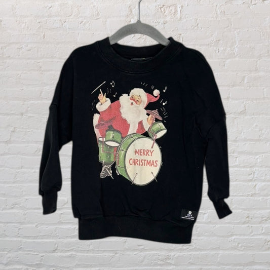 Black sweater featuring a Merry Christmas graphic with Santa playing drums in festive design.