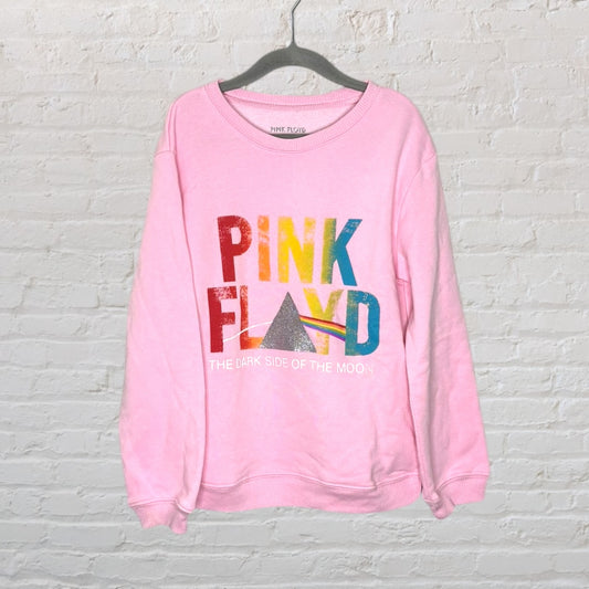 Pink sweatshirt featuring Pink Floyd's 'The Dark Side of the Moon' graphic with multicolored text and prism design.